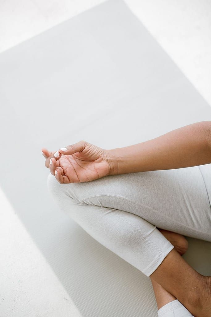 A person engaging in yoga, with zodiac symbols overlaid, showing how astrology can guide individual wellness practices.