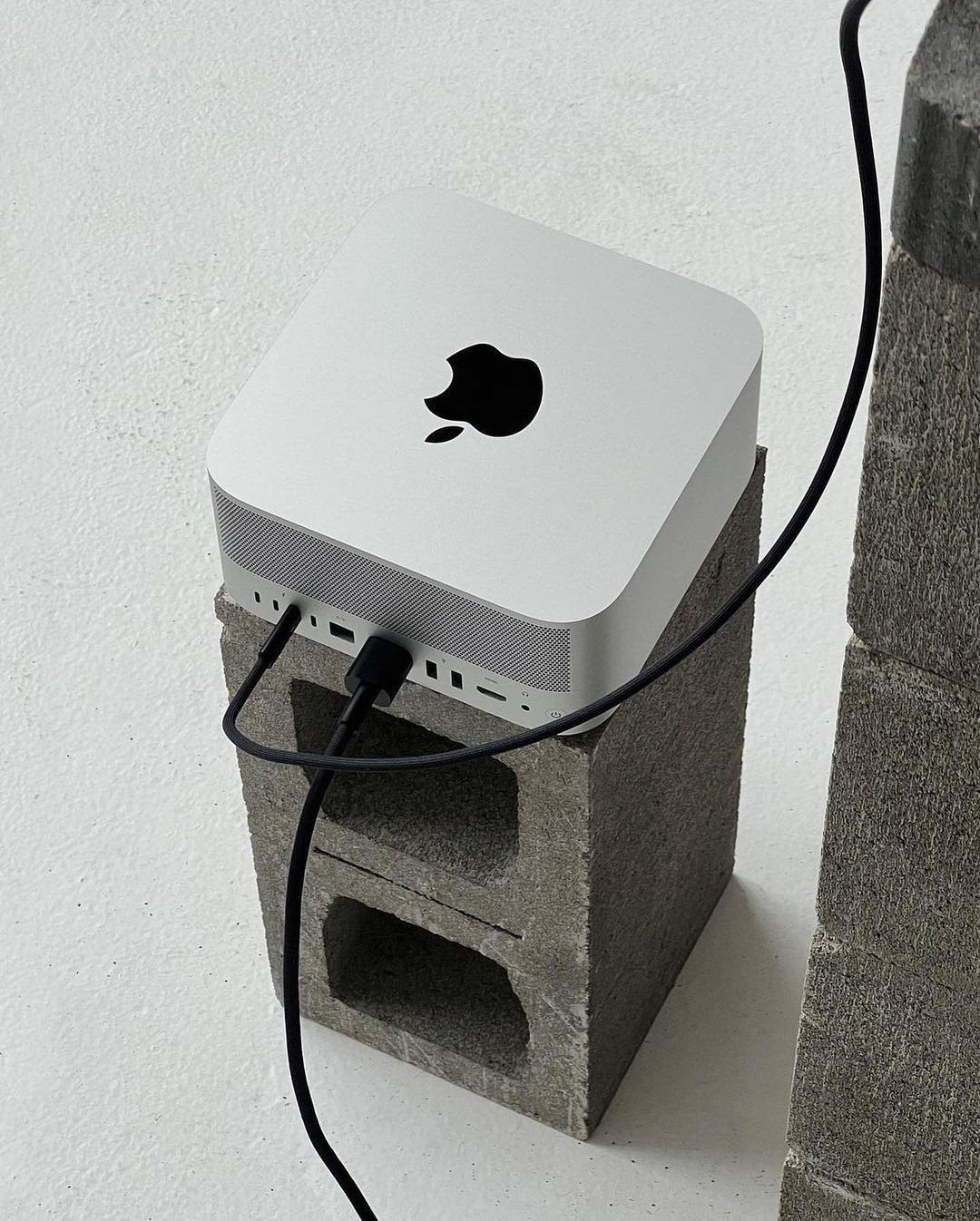 A Mac Studio computer in a brutalist-inspired desk setup.