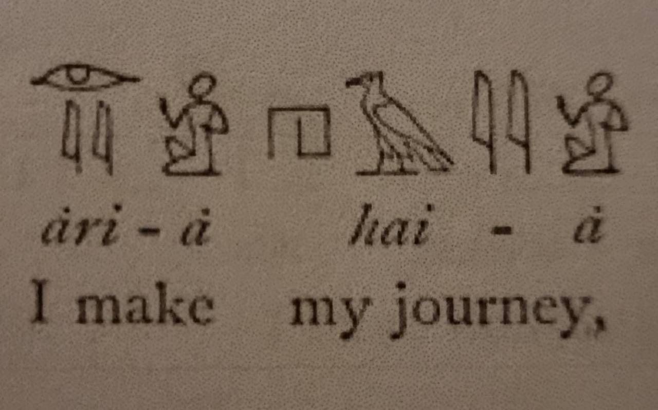 Egyptian hieroglyphs translating to 'I make my journey'.