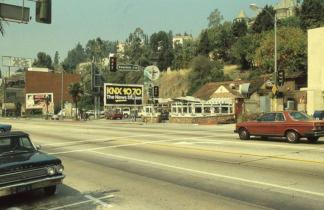 The intersection of Sunset Boulevard and Sweetzer Avenue in Los Angeles, 1985, featuring a billboard for Angelyne.