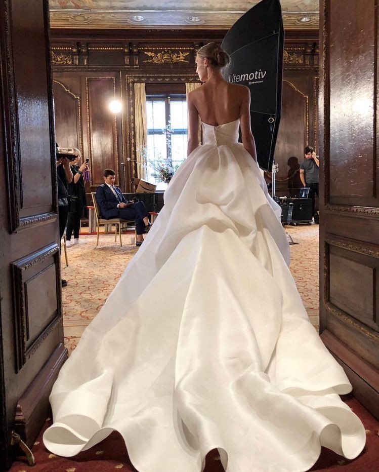 A Truly Zac Posen Wedding Dress seen from behind during a photoshoot.