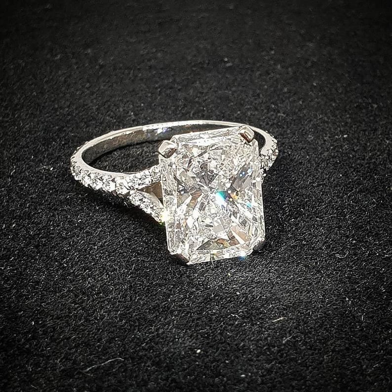 A 5 Carat Radiant Cut Diamond Engagement Ring with a split shank pavé band by DiamondFineJewelry.