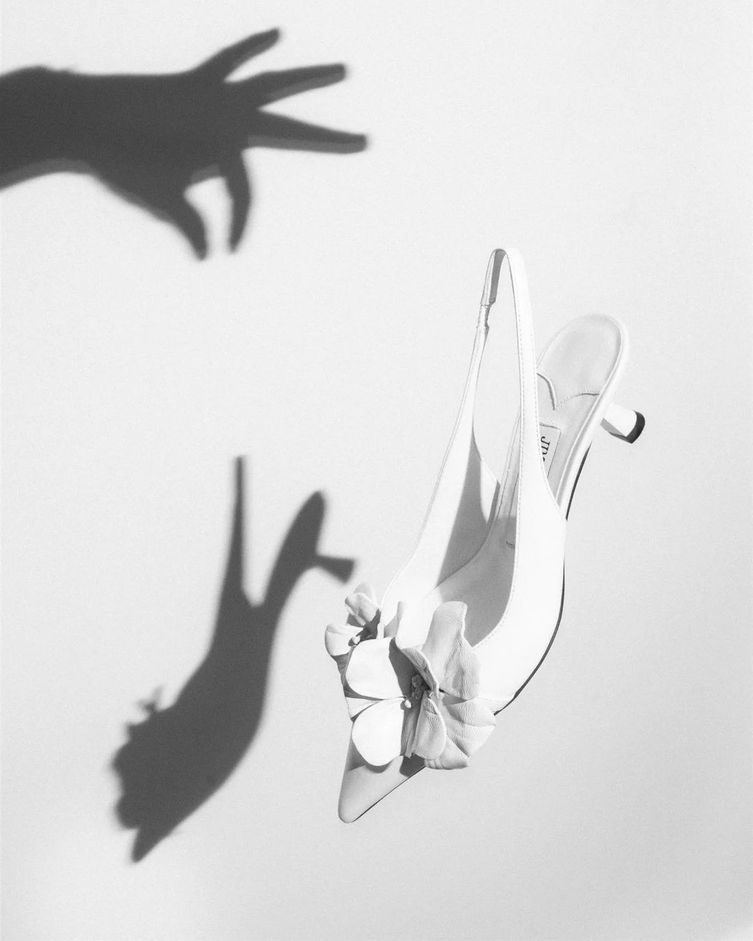 An editorial photograph of a wedding shoe by Jimmy Choo.