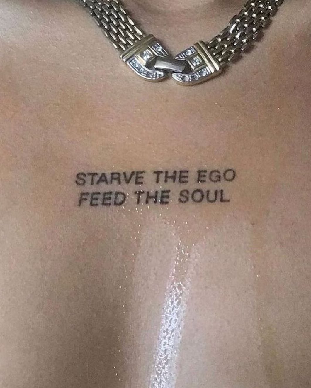 A tattoo reads "Starve the Ego, Feed the Soul."