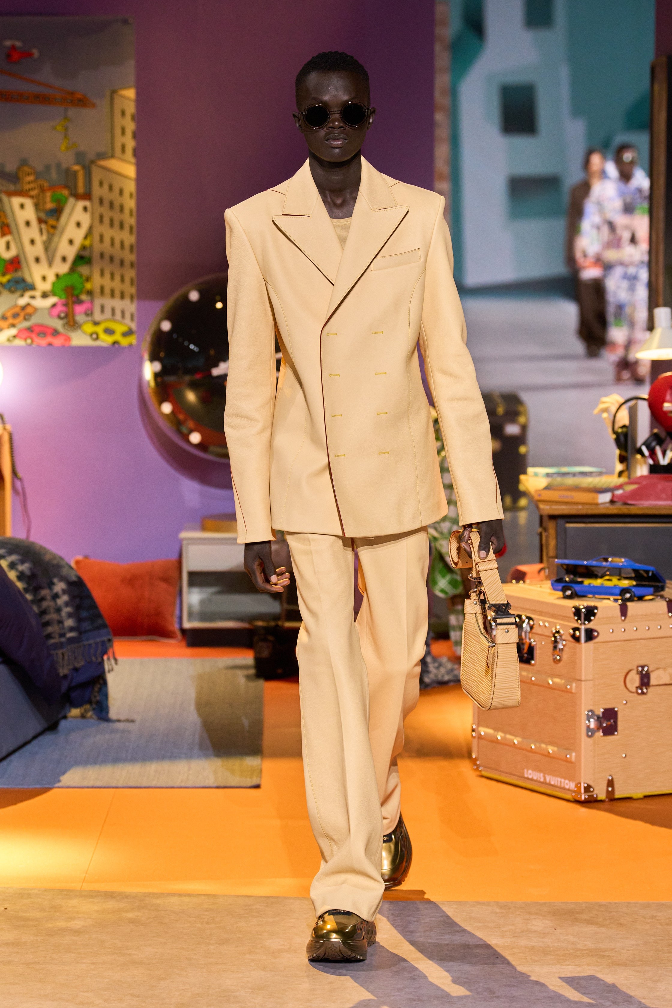 Model Wal Ruop in the Louis Vuitton Fall 2023 Menswear collection, guest-designed by Colm Dillane.