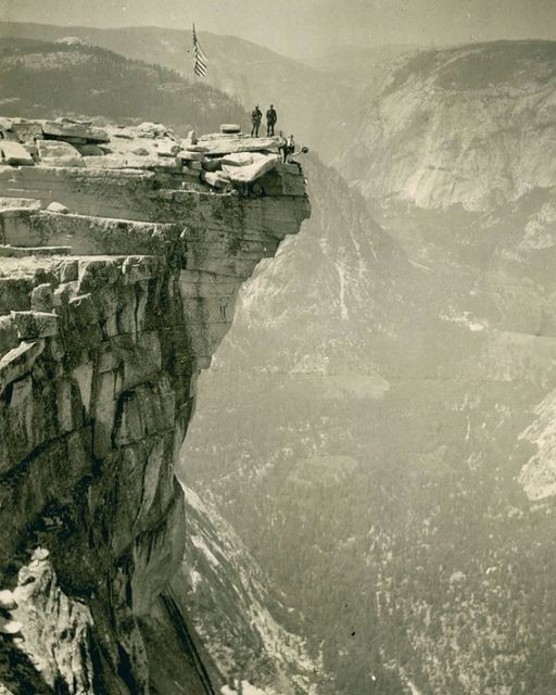 Explorers on the overhang at Half Dome, 5000 ft above Yosemite Valley, 1920.
