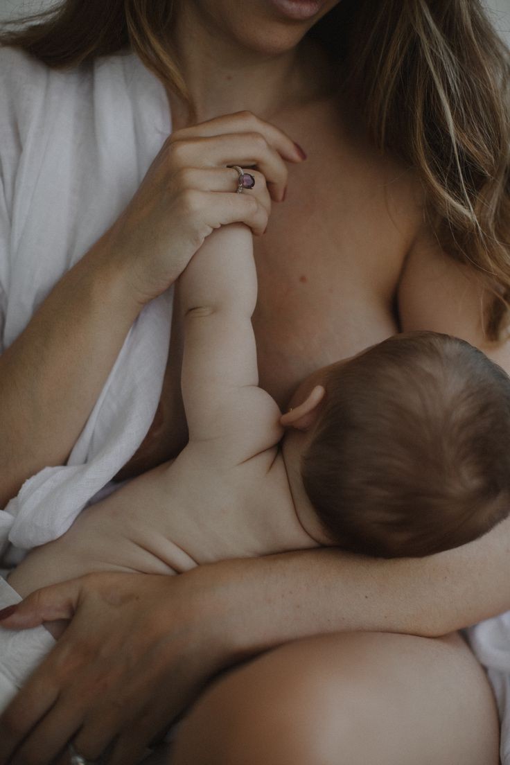 A mother tenderly nursing her baby