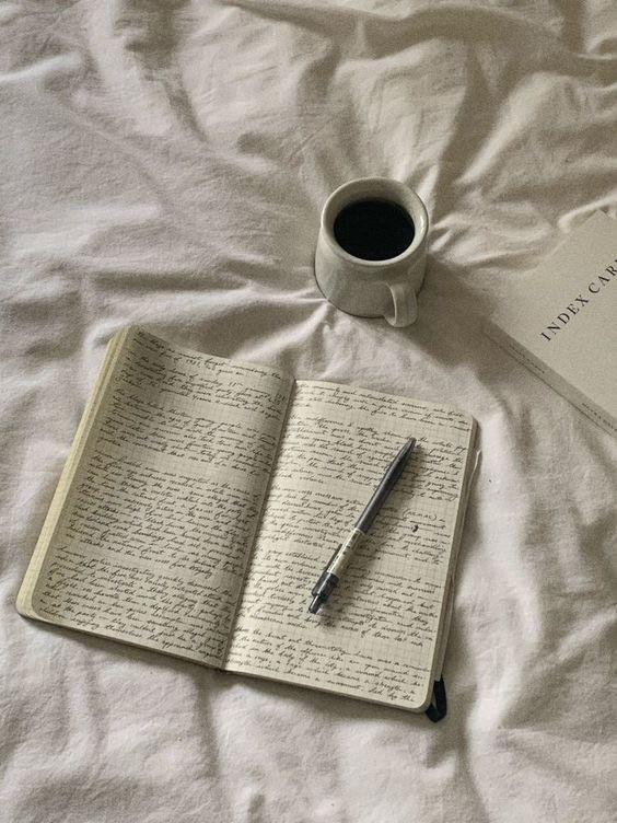 A wellness journal and cup of tea, symbolizing mindful practices to connect with your menstrual cycle.