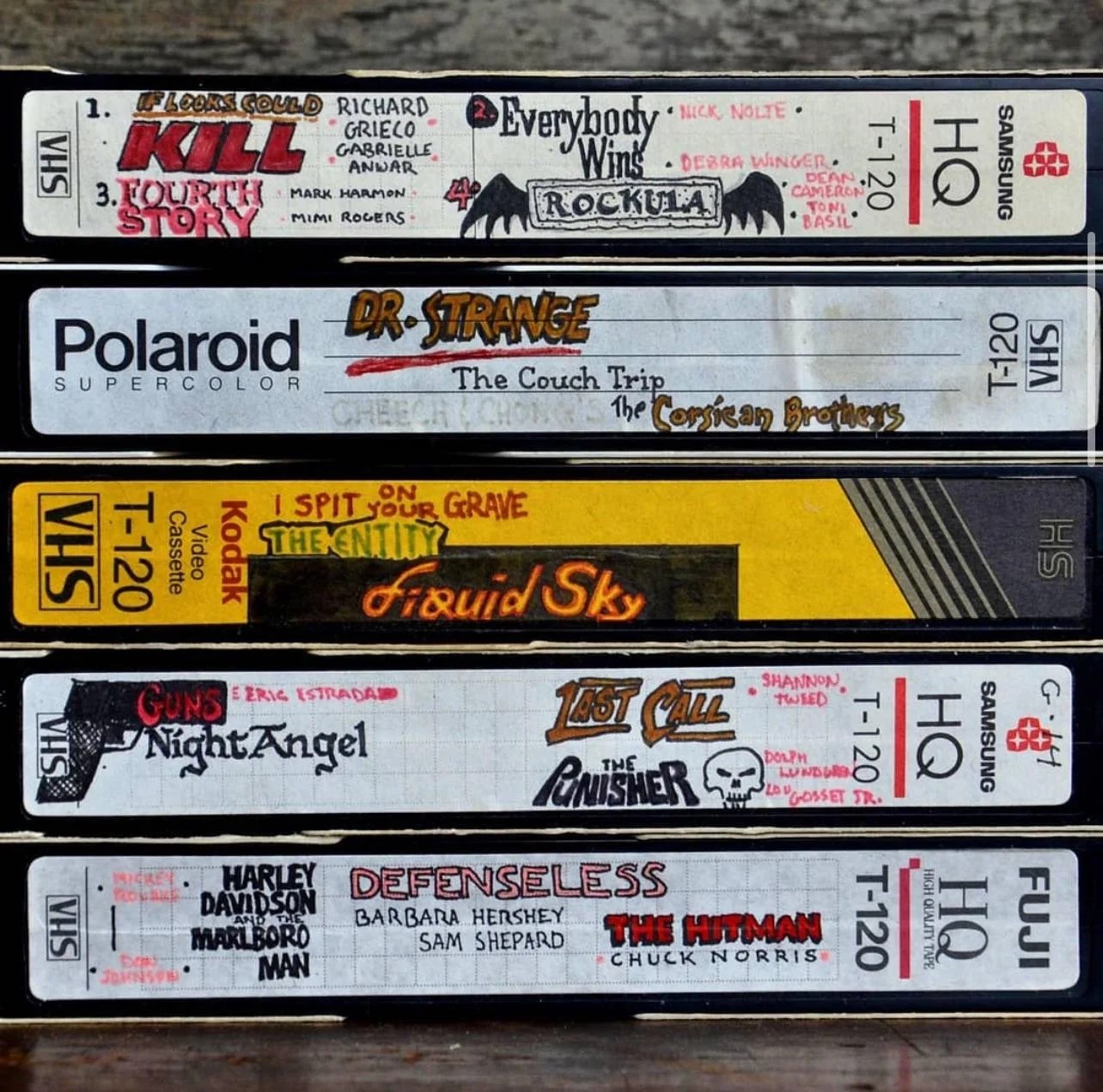 Handwritten labels on VHS tapes from a private collection, including Dr. Strange and The Punisher.