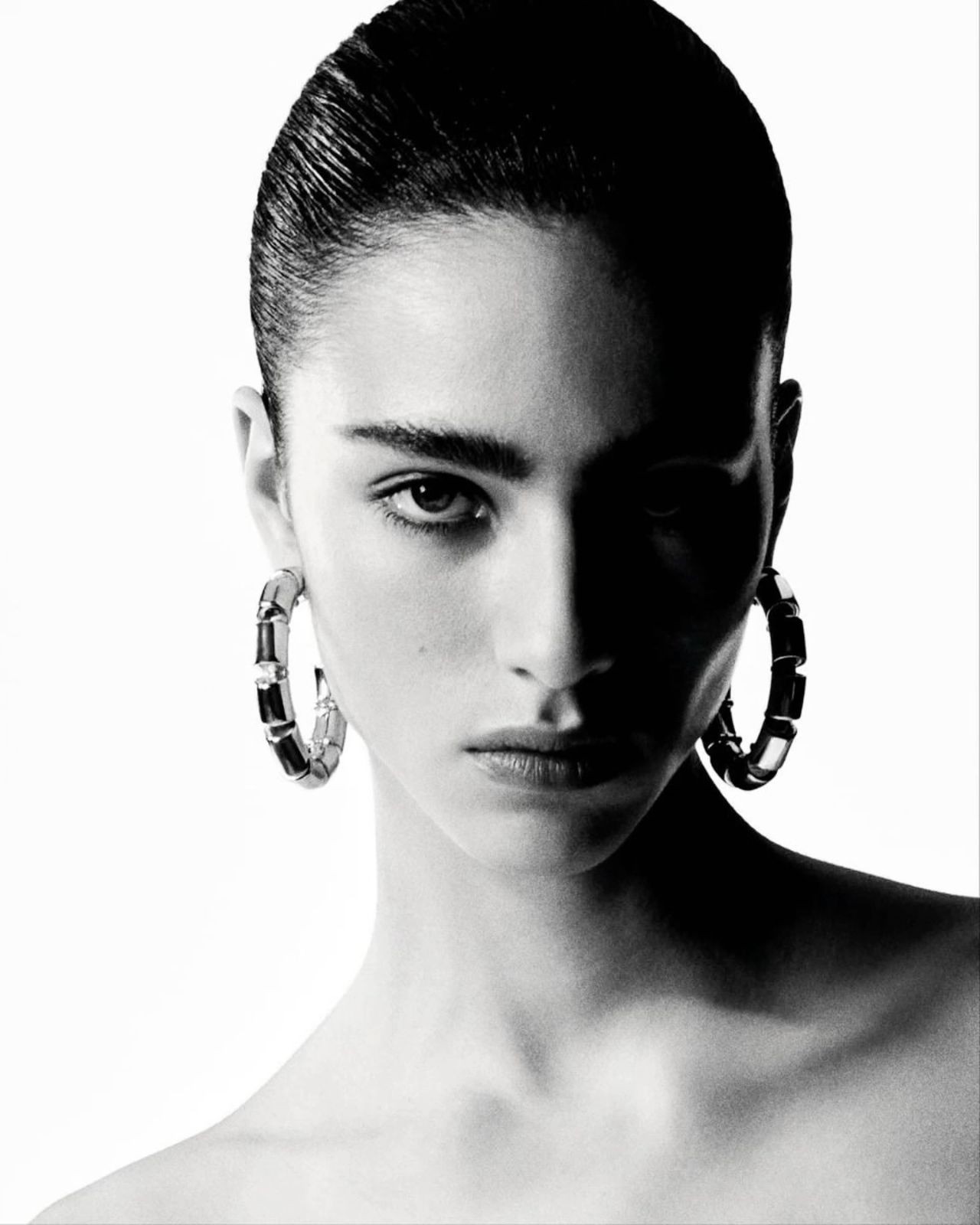 A portrait featuring Gucci Bamboo earrings.